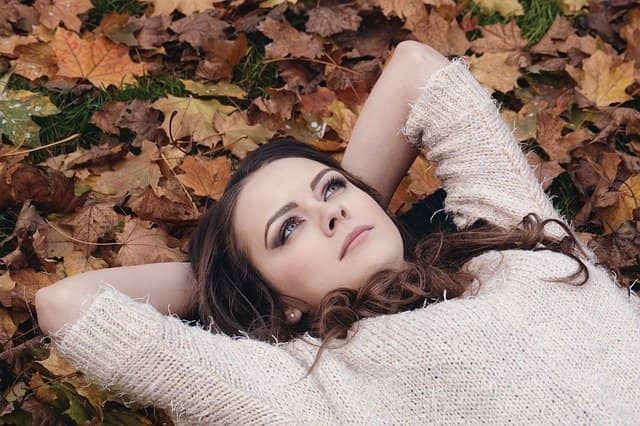 Ležiaci žena v jesennom lístia